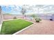 Landscaped backyard featuring string lights, synthetic grass, and desert landscaping at 3402 N 300Th Dr, Buckeye, AZ 85396