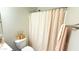 Clean and functional bathroom with a toilet and shower with neutral colored shower curtain at 3402 N 300Th Dr, Buckeye, AZ 85396