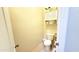 Cozy half bathroom features a toilet and custom shelf with storage space at 3402 N 300Th Dr, Buckeye, AZ 85396