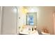 Bright bathroom features a white vanity with a square mirror and decorative elements that enhance the space at 3402 N 300Th Dr, Buckeye, AZ 85396
