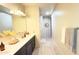 Bright and airy bathroom with double sinks, a large mirror, and plank flooring at 3402 N 300Th Dr, Buckeye, AZ 85396