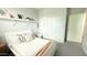 Bright bedroom features a white bed and gray carpet flooring, complemented by a sliding door closet at 3402 N 300Th Dr, Buckeye, AZ 85396