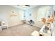 Inviting bedroom with gray carpet, light walls, a piano, vanity, and decorative accents at 3402 N 300Th Dr, Buckeye, AZ 85396