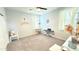 Neutral bedroom with light carpet, light walls, ceiling fan, and window providing lots of natural light at 3402 N 300Th Dr, Buckeye, AZ 85396