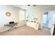 Comfortable bedroom with light carpet, desk, piano, decor, and neutral tones at 3402 N 300Th Dr, Buckeye, AZ 85396