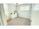 Bright bedroom with gray carpet, a window, and a white dresser, offering a serene and inviting atmosphere at 3402 N 300Th Dr, Buckeye, AZ 85396