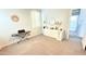 Bright bedroom space with light carpet, vanity, piano, and walk out to the rest of the house at 3402 N 300Th Dr, Buckeye, AZ 85396