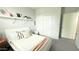 Stylized bedroom features a white bed and gray carpet flooring, complemented by a sliding door closet at 3402 N 300Th Dr, Buckeye, AZ 85396