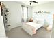 Comfortable bedroom featuring a white bed with throw pillows and a throw blanket, and decorative shelves at 3402 N 300Th Dr, Buckeye, AZ 85396