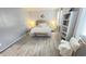 A calming primary bedroom with a bench, light gray walls and plank flooring at 3402 N 300Th Dr, Buckeye, AZ 85396
