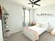 Cozy bedroom with soft gray walls and carpet, complemented by a white bed and matching decorative shelves at 3402 N 300Th Dr, Buckeye, AZ 85396