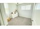 Bright bedroom with gray carpet, large window, and a white dresser, offering a serene and inviting atmosphere at 3402 N 300Th Dr, Buckeye, AZ 85396