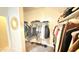 Walk in closet features built in shelving and hanging racks for storing clothing at 3402 N 300Th Dr, Buckeye, AZ 85396