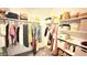 Walk in closet features built in shelving and hanging racks for storing clothing at 3402 N 300Th Dr, Buckeye, AZ 85396