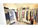 Walk in closet features built in shelving and hanging racks for storing clothing at 3402 N 300Th Dr, Buckeye, AZ 85396