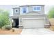 Well-maintained two-story home featuring desert landscaping and a two-car garage at 3402 N 300Th Dr, Buckeye, AZ 85396