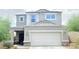 Lovely two-story home featuring desert landscaping and a two-car garage at 3402 N 300Th Dr, Buckeye, AZ 85396