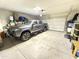 Spacious garage with a gray truck parked inside and ample storage space available at 3402 N 300Th Dr, Buckeye, AZ 85396