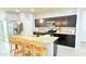 Spacious kitchen with breakfast bar, dark cabinets, and stainless steel appliances at 3402 N 300Th Dr, Buckeye, AZ 85396