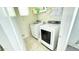 Functional laundry room featuring modern Samsung washer and dryer, and neutral tile flooring at 3402 N 300Th Dr, Buckeye, AZ 85396