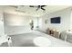 Bright living area with gray walls and plush carpet, flowing to laundry room with view of modern appliances at 3402 N 300Th Dr, Buckeye, AZ 85396