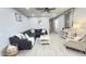 Cozy living room features a gray sectional sofa and charming decor at 3402 N 300Th Dr, Buckeye, AZ 85396