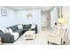 Comfortable living room showcases a gray sectional sofa, round mirror, and stylish decor at 3402 N 300Th Dr, Buckeye, AZ 85396