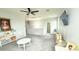 Bright and open living room with neutral decor, a ceiling fan, and a mounted TV at 3402 N 300Th Dr, Buckeye, AZ 85396