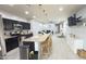 Bright open-concept showcases kitchen island with seating flowing into the comfortable living area at 3402 N 300Th Dr, Buckeye, AZ 85396