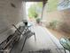 Charming patio with outdoor seating and a view of the landscaped front yard at 3402 N 300Th Dr, Buckeye, AZ 85396