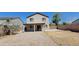 Two-story home with covered patio and large backyard with gravel landscaping at 3405 W La Salle St, Phoenix, AZ 85041