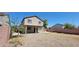 View of the two-story home with covered patio and gravel backyard landscaping at 3405 W La Salle St, Phoenix, AZ 85041