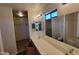 Bathroom featuring double sinks, wood-look flooring, and a view to the walk-in closet and toilet room at 3405 W La Salle St, Phoenix, AZ 85041