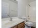 Bright bathroom features wood cabinet, white sink, toilet and shower-tub combo at 3405 W La Salle St, Phoenix, AZ 85041