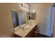 Bathroom featuring double sinks, wood-look flooring, and lighting that brighten up the space at 3405 W La Salle St, Phoenix, AZ 85041