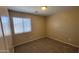 Cozy carpeted bedroom features a large window and a neutral color palette at 3405 W La Salle St, Phoenix, AZ 85041