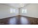 Spacious bedroom with hardwood flooring and ceiling fan with an abundance of light at 3405 W La Salle St, Phoenix, AZ 85041