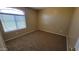This bedroom boasts neutral walls, carpet flooring, and a window providing natural light at 3405 W La Salle St, Phoenix, AZ 85041