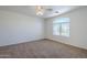 Comfortable bedroom featuring plush carpet, a ceiling fan and a large window at 3405 W La Salle St, Phoenix, AZ 85041