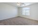 Carpeted bedroom with a ceiling fan and window at 3405 W La Salle St, Phoenix, AZ 85041