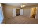 Bedroom with carpet floors, neutral walls, ceiling fan, and an ensuite bathroom for added privacy at 3405 W La Salle St, Phoenix, AZ 85041