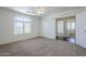 Bright bedroom with carpet, large window, and entry to another room at 3405 W La Salle St, Phoenix, AZ 85041