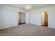 Carpeted bedroom with a ceiling fan, closet and entry to another room at 3405 W La Salle St, Phoenix, AZ 85041