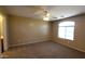 Bedroom featuring a ceiling fan, neutral walls, carpet flooring, and natural light from the window at 3405 W La Salle St, Phoenix, AZ 85041