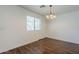 Dining room with hardwood floors, window and decorative chandelier at 3405 W La Salle St, Phoenix, AZ 85041