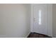 Entryway featuring white front door with decorative glass pane and hardwood flooring at 3405 W La Salle St, Phoenix, AZ 85041