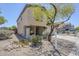 Two-story home with desert landscaping featuring mature tree and rock accents at 3405 W La Salle St, Phoenix, AZ 85041