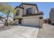 Two-story home featuring a two-car garage, neutral stucco, and desert landscaping at 3405 W La Salle St, Phoenix, AZ 85041