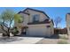 Two-story home featuring a two-car garage, desert landscaping, and neutral stucco exterior at 3405 W La Salle St, Phoenix, AZ 85041