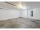 Garage with painted walls, garage door, and hot water heater at 3405 W La Salle St, Phoenix, AZ 85041